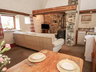 a living room with a couch and a table at Ty Tarw in Llanybydder