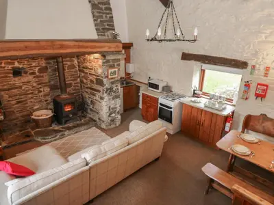 a living room with a couch and a fireplace at Ty Tarw in Llanybydder