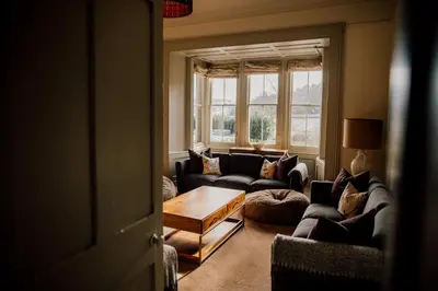 a living room with couches and a coffee table at Wilde Lodge by Birch Stays in Bucknell