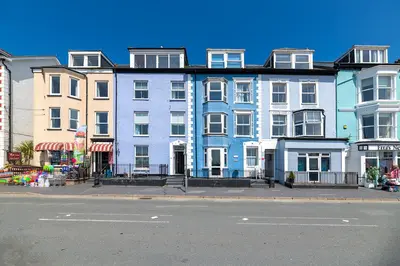 a row of buildings on a city street with a street at Spacious 3 Bedroom Sea View Flat in Aberdyfi