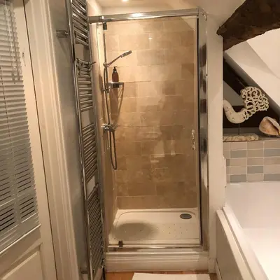 a shower with a glass door in a bathroom at Logaston Common Farmhouse in Woonton