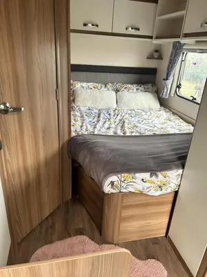 a bed in a small room in a camper van at Carol Anns Caravan, Working Farm Stay, Rural, Private, Fire Pit for hire, Dogs on request in Pontesbury