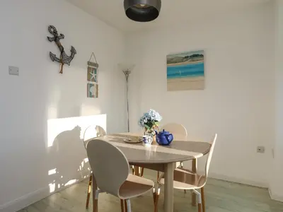 a dining room with a table and chairs at Sandcastles in Barmouth