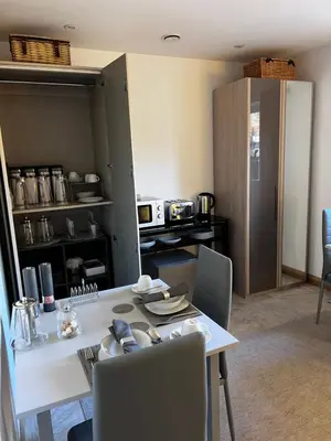 a dining room with a white table and chairs at Falconwood in Ifton Heath
