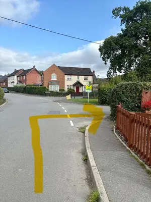 a street with yellow paint on the road at Falconwood in Ifton Heath