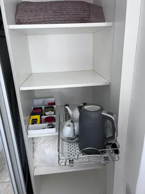 a cabinet with a tea pot and a mixer in it at Falconwood in Ifton Heath