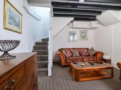 a living room with a couch and a table at The Courtyard Cottage in Llangollen