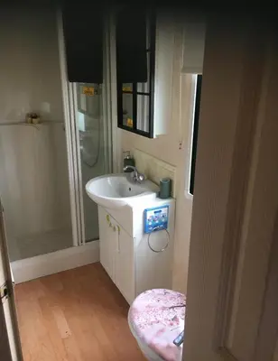 a bathroom with a sink and a shower at 2 Bed Caravan - Sleeps 4 - Pets - Parking - Wifi in Aberystwyth