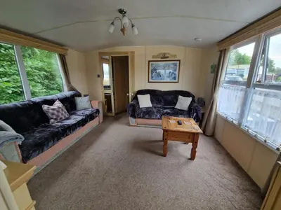 a living room with a couch and a coffee table at 2 Bed Caravan - Sleeps 6 - Pets - Pool - Parking in Aberystwyth