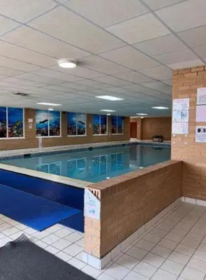 a large swimming pool in a large building at 2 Bed Caravan - Sleeps 6 - Pets - Pool - Parking in Aberystwyth