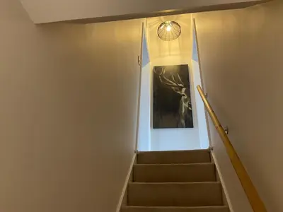 a staircase with a painting and a light fixture at Little Hotspur in Shrewsbury