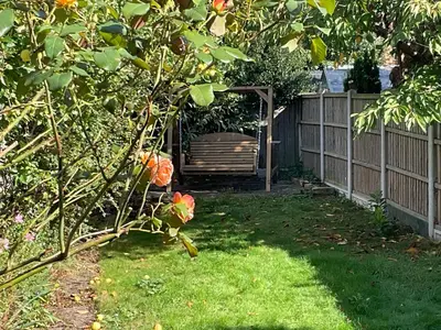 a backyard with a fence and a wooden gate at Little Hotspur in Shrewsbury