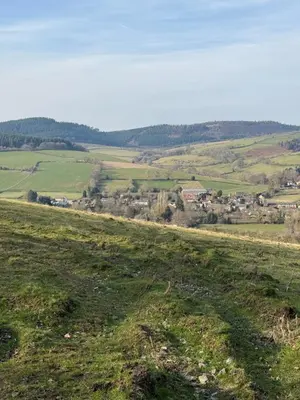 a green field with a town in the distance at Charming 2 bedroom Lodge In the Shropshire Countryside with Fantastic Views in Clunton