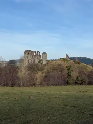 a castle on top of a hill in a field at Charming 2 bedroom Lodge In the Shropshire Countryside with Fantastic Views in Clunton
