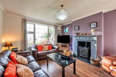 a living room with leather furniture and a fireplace at Finest Retreats - Tan y Fron Hideaway in Dyffryn