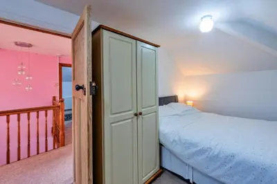 a small bedroom with a bed and a closet at Finest Retreats - Tan y Fron Hideaway in Dyffryn