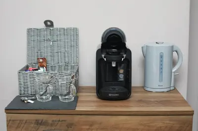 a coffee maker and a blender on a wooden shelf at OYO Glyn Valley Hotel in Glyn-Ceiriog