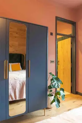 a bedroom with a bed and a large mirror at Old Chapel Llanfrynach in Brecon