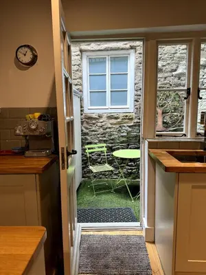 a kitchen with a door leading to a patio at The Cottage, Upper Linney, Ludlow in Ludlow