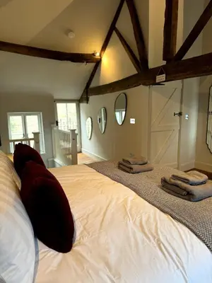 a bedroom with a large bed with towels on it at The Cottage, Upper Linney, Ludlow in Ludlow
