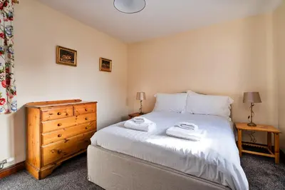a bedroom with a bed with two towels on it at Finest Retreats - Walton Maisonette in Onibury