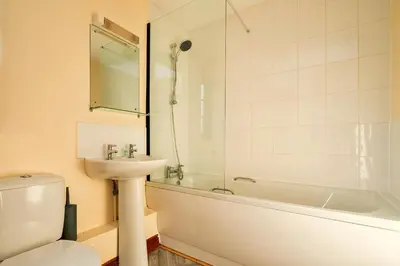 a bathroom with a sink and a tub and a toilet at Finest Retreats - Walton Maisonette in Onibury