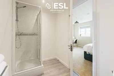 a glass shower in a room with a bedroom at 4 bedroom house in Shrewsbury with parking in Shrewsbury