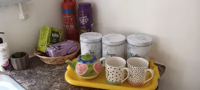 a shelf with four coffee mugs on it at Robins nest in Great Hanwood