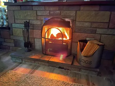 a brick fireplace with a fire in it at Golygfa'r Orsaf Snowdonia national park, Bala lake in Bala