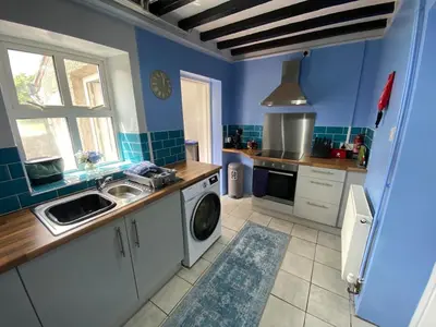 a kitchen with a sink and a washing machine at Golygfa'r Orsaf Snowdonia national park, Bala lake in Bala