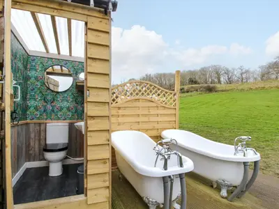 a bathroom with a toilet and a tub and a sink at Meadow View - Bryn-Mawr Retreat in Llanymynech