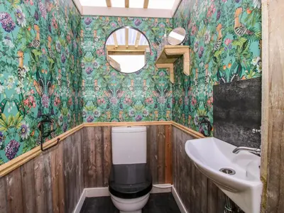 a bathroom with a toilet and a sink at Meadow View - Bryn-Mawr Retreat in Llanymynech