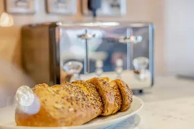 a plate of bread on a counter next to a toaster at 4 Bed in Llansanffraid oc-p30384 in Llanymynech