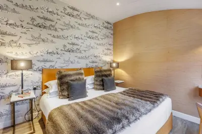 a bedroom with a bed and a wall covered in wallpaper at 4 Bed in Llansanffraid oc-p30384 in Llanymynech