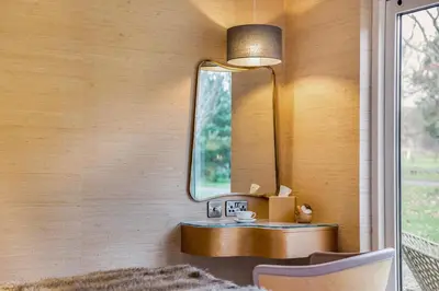 a mirror on a wall with a table and a chair at 4 Bed in Llansanffraid oc-p30384 in Llanymynech