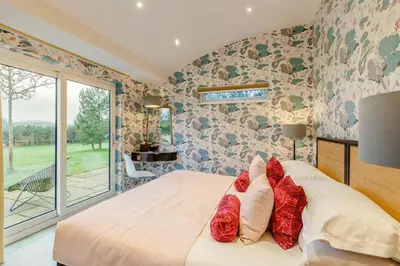 a bedroom with a bed with red pillows on it at 4 Bed in Llansanffraid oc-k30383 in Llanymynech