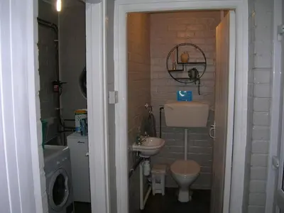 a small bathroom with a sink and a toilet at Bevan House with Hot Tub in Mid-Wales in Hundred House