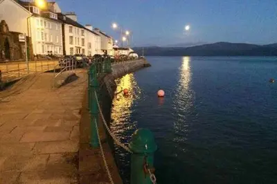 a body of water with buildings and a street at Westhaven 5 Beachfront Luxury-Free parking permit in Aberdyfi