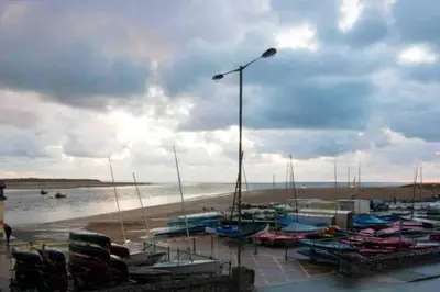 a group of boats are docked at a harbor at Westhaven 5 Beachfront Luxury-Free parking permit in Aberdyfi