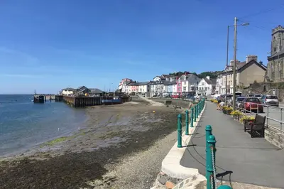 a view of a beach with houses and the water at Westhaven 5 Beachfront Luxury-Free parking permit in Aberdyfi