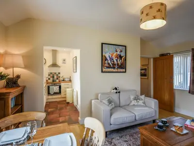 a living room with a couch and a table at The Old Milking Parlour in Melverley