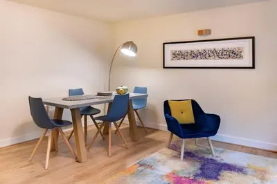 a dining room with a table and chairs and a desk at 1-bedroom apartment Shrewsbury town centre in Shrewsbury