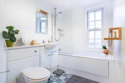 a white bathroom with a toilet and a sink at 1-bedroom apartment Shrewsbury town centre in Shrewsbury