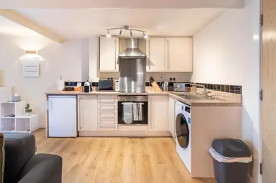 a kitchen with a washer and dryer at 1-bedroom apartment Shrewsbury town centre in Shrewsbury