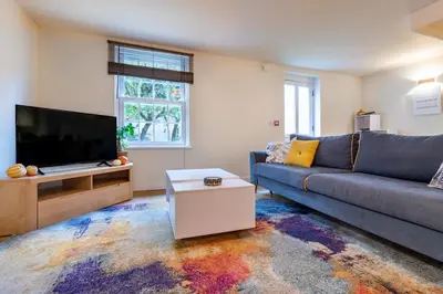 a living room with a couch and a tv at 1-bedroom apartment Shrewsbury town centre in Shrewsbury