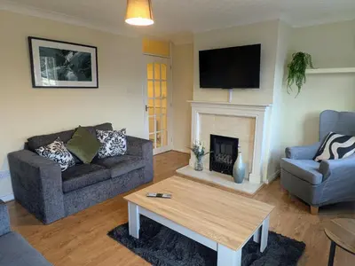a living room with a couch and a fireplace at Theatre Severn Town House, Parking & Quarry Views in Shrewsbury