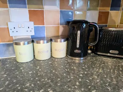 three coffee cups sitting on a kitchen counter at Theatre Severn Town House, Parking & Quarry Views in Shrewsbury