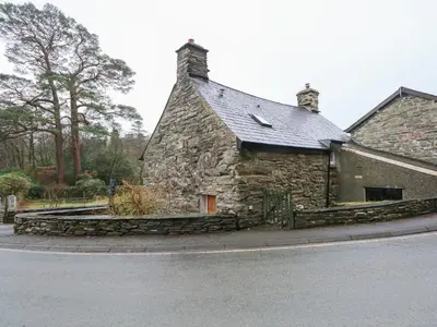 an old stone building on the side of a street at Tafarn Trip in Blaenau-Ffestiniog