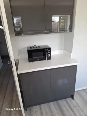 a kitchen with a counter with a microwave on it at Shrewsbury Creations in Shrewsbury