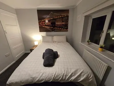 a bedroom with a bed with a towel on it at Shrewsbury Creations in Shrewsbury